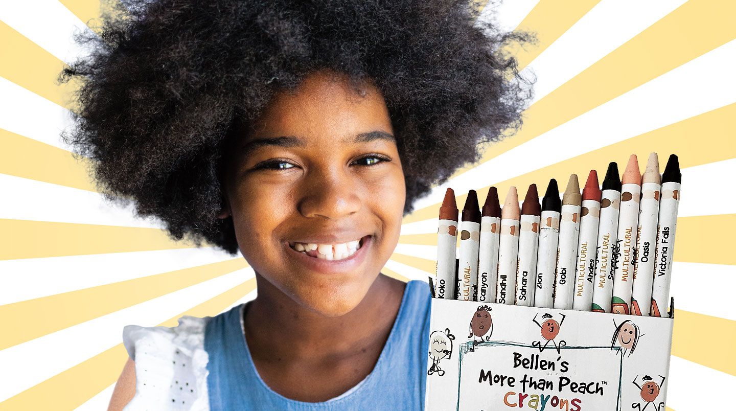 Bellen Woodard smiles while holding a box of crayons.