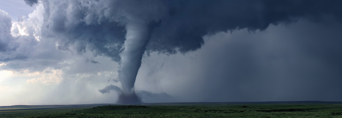 Image of a twister traveling over flat field